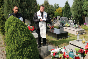 policjant i kapelan przed grobem podinspektora Bogdana Laskowskiego